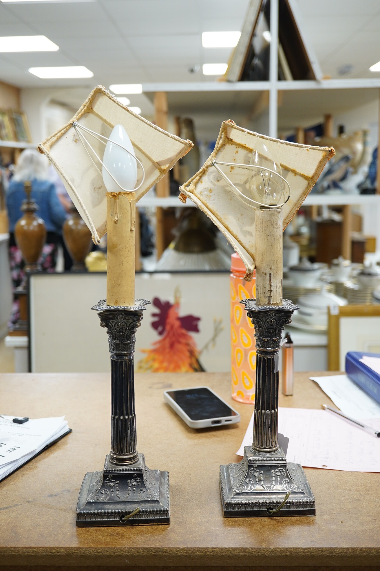 A pair of late Victorian silver Corinthian column candlesticks, now drilled for electricity and converted to lamps, James Dixon & Sons, Ltd, Sheffield, 1894, sticks only 21.8cm, weighted. Condition - poor